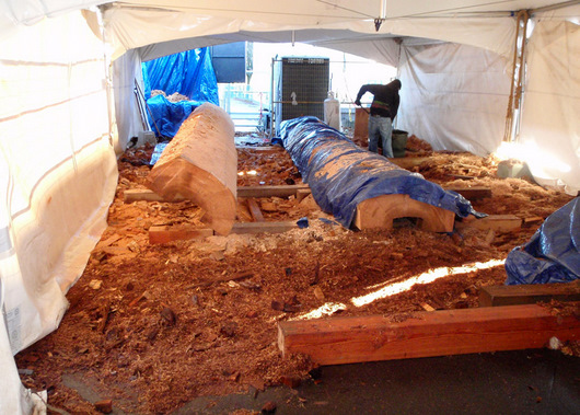Totem poles in the waiting, and the nearly 4 tonnes of wood waste before Green Coast Rubbish