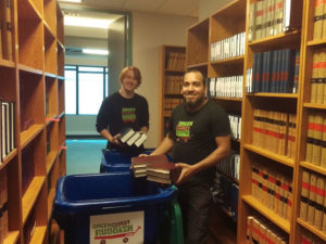 Sean and Karim doing book recycling in a library